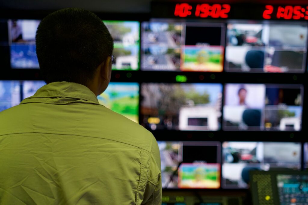 Person watching many live data screens, showing the benefits of digital twin technology for data skills