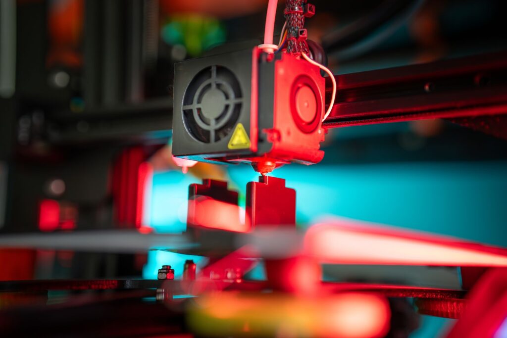 3D printer building a physical part from a digital model, a first step towards digital twin technology in education