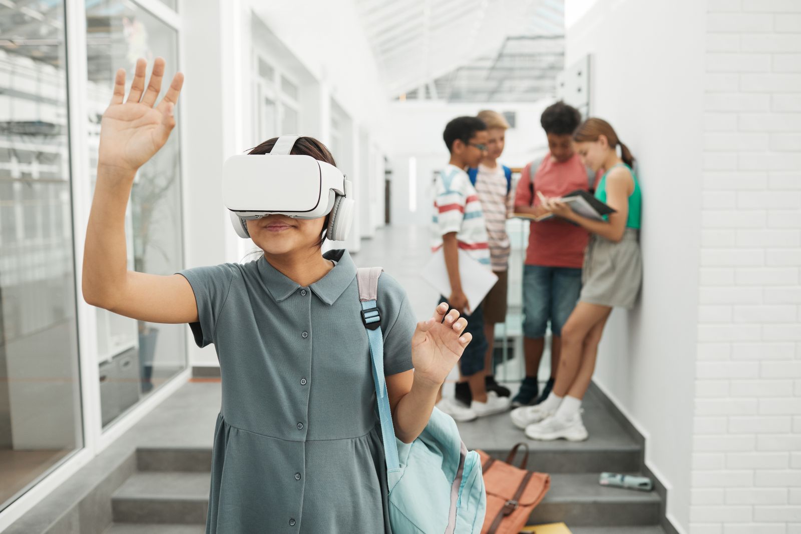Girl in a school corridor exploring extended reality in education with a VR headset