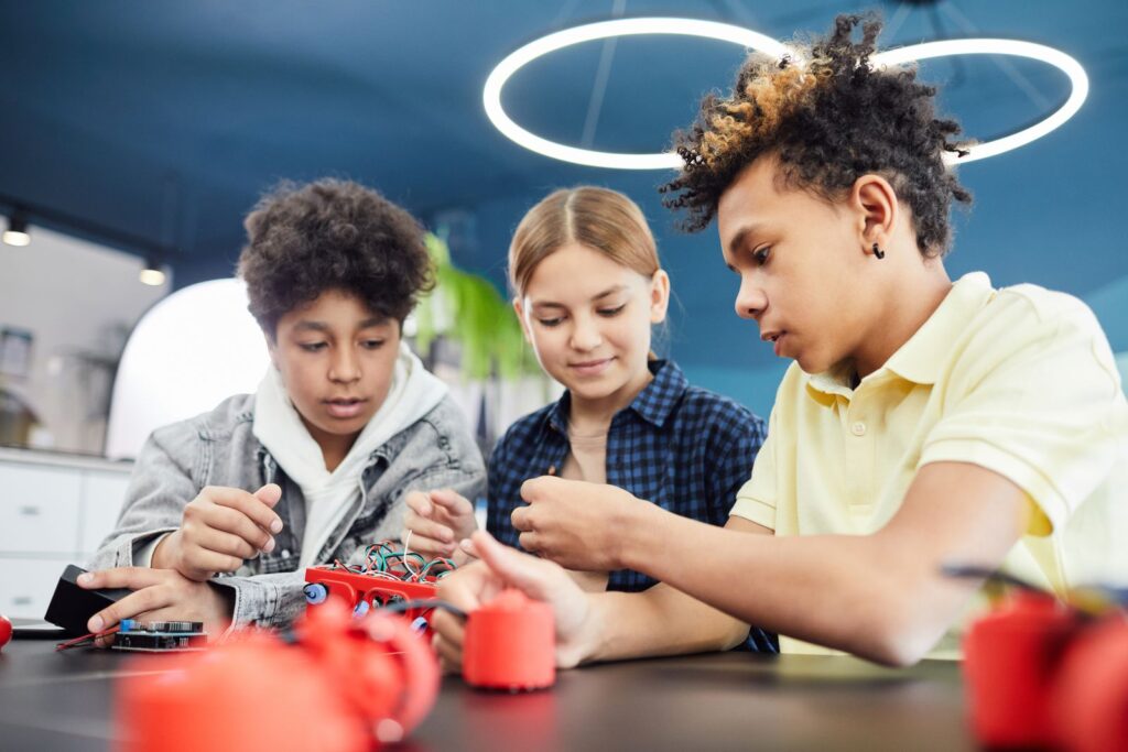 Students building robots, a hands-on area that extended reality in STEM education supports