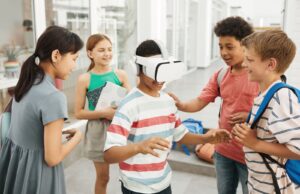 Students in a school corridor trying extended reality in STEM education with a VR headset