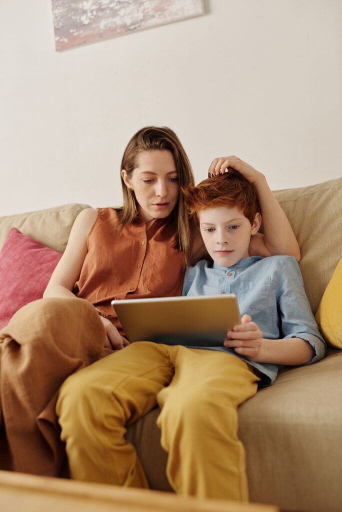 Parent and child using a tablet, an augmented reality example in the extended reality vs virtual reality debate