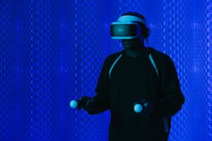 Person in a VR headset with controllers, used to compare extended reality vs virtual reality for learning