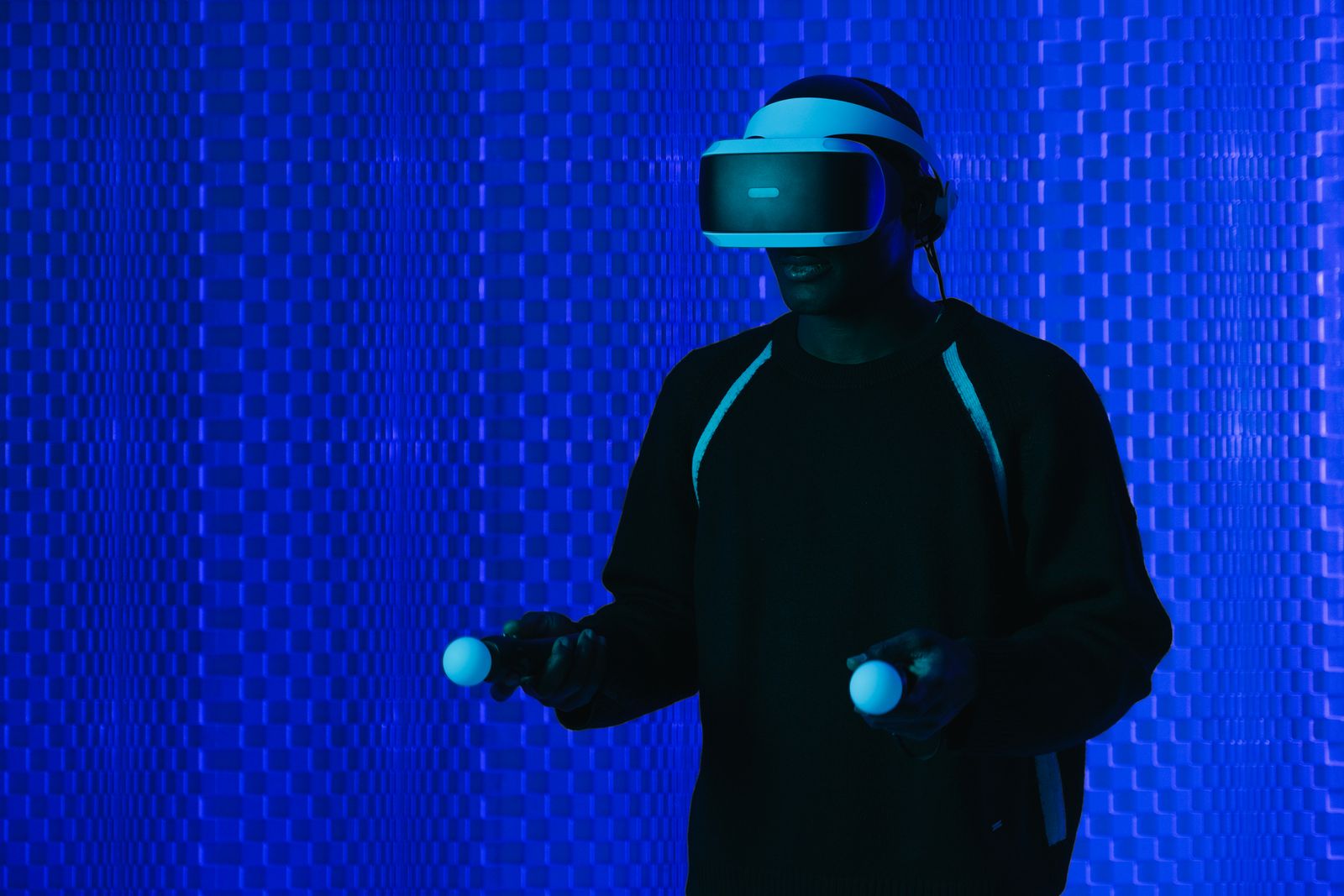 Person in a VR headset with controllers, used to compare extended reality vs virtual reality for learning