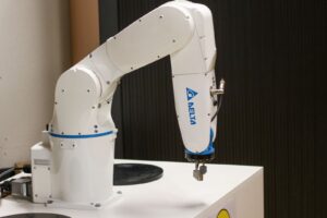 An industrial robotic arm in an automated cell, a key area for Industry 4.0 skills