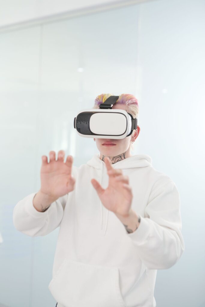 A person in a white hoodie using a VR headset for metaverse in education activities
