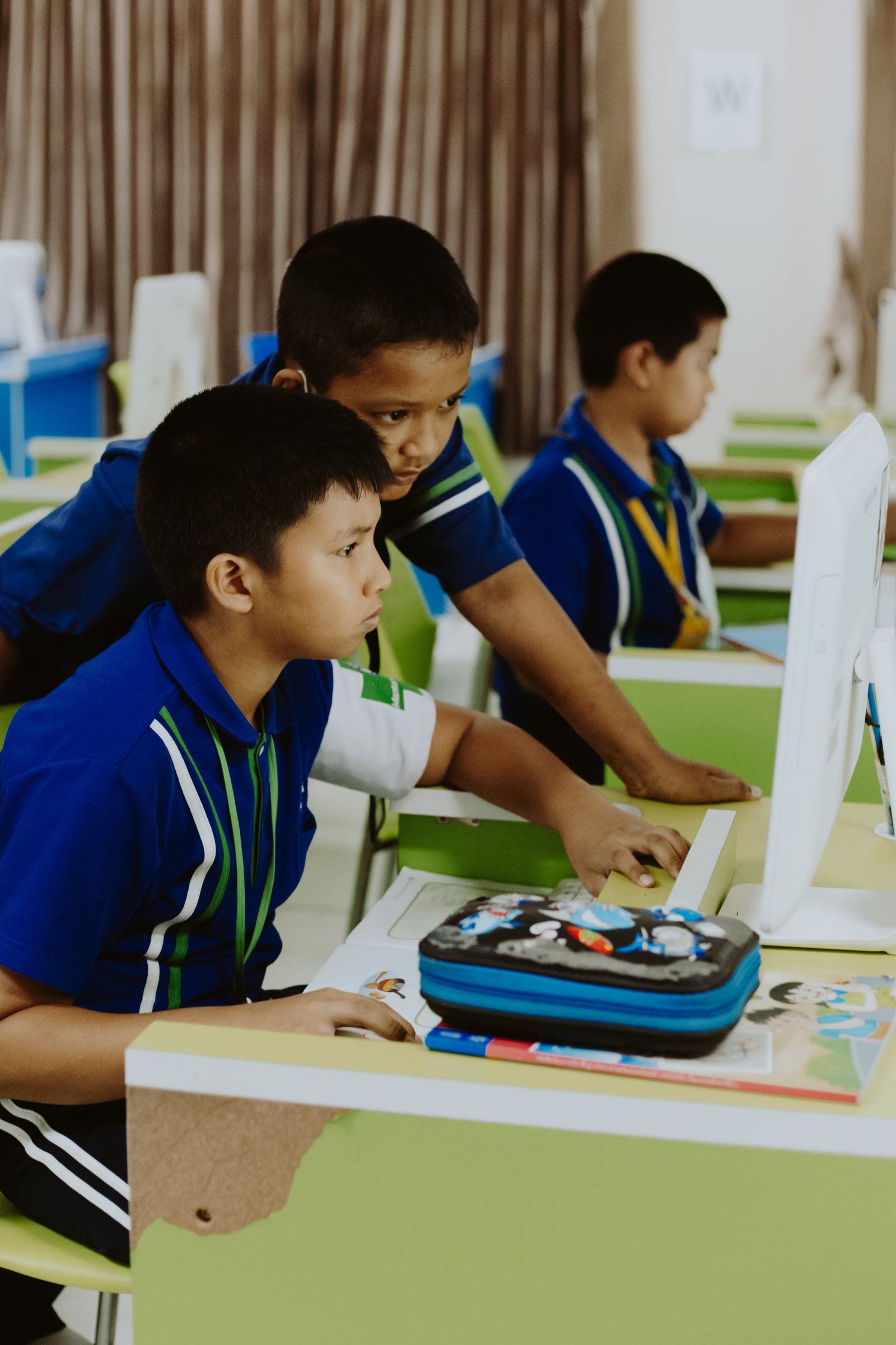 Students working at computers in a bright room set up as an XR lab for colleges