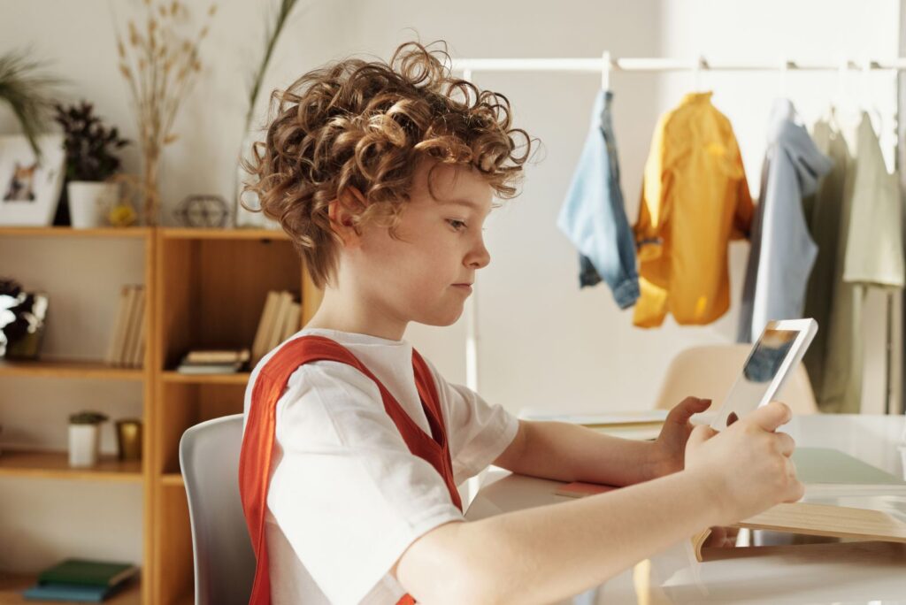 Child using a tablet for XR learning with augmented reality