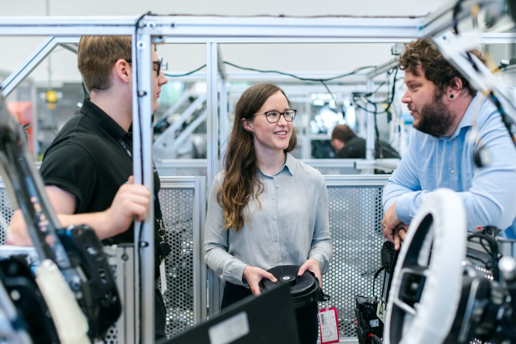 Engineers discussing equipment in a workshop, part of an XR skill training programme
