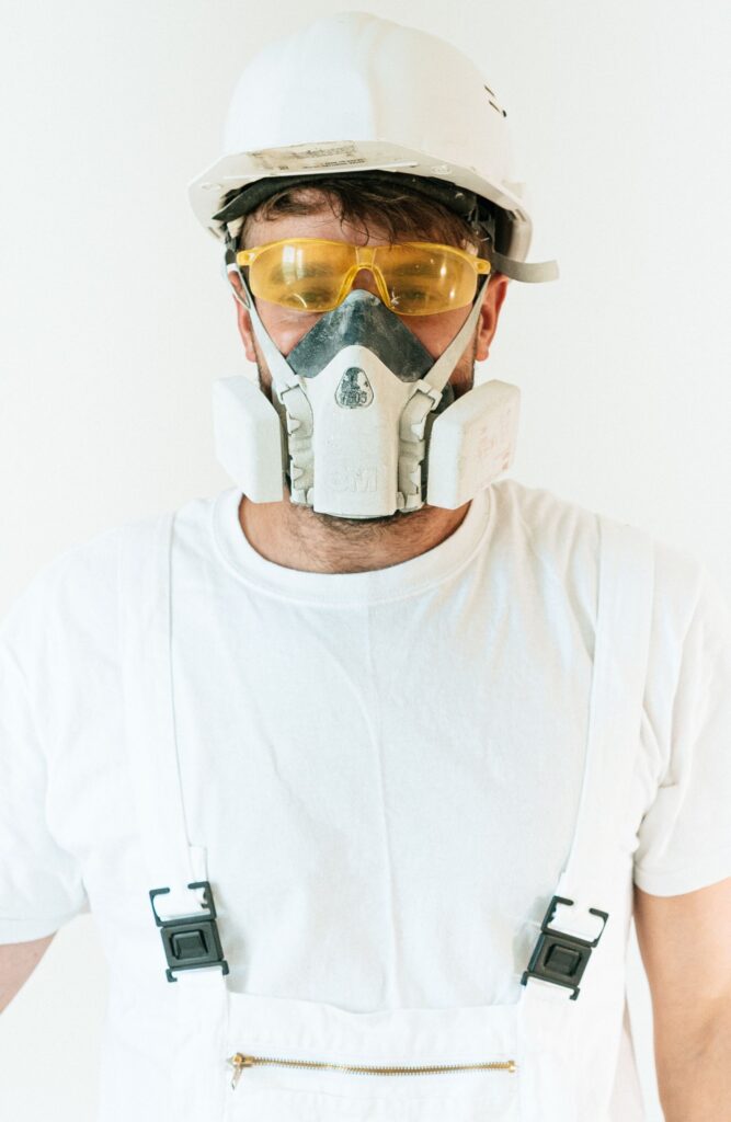 A worker in safety glasses and helmet, prepared through XR skill training for safe work